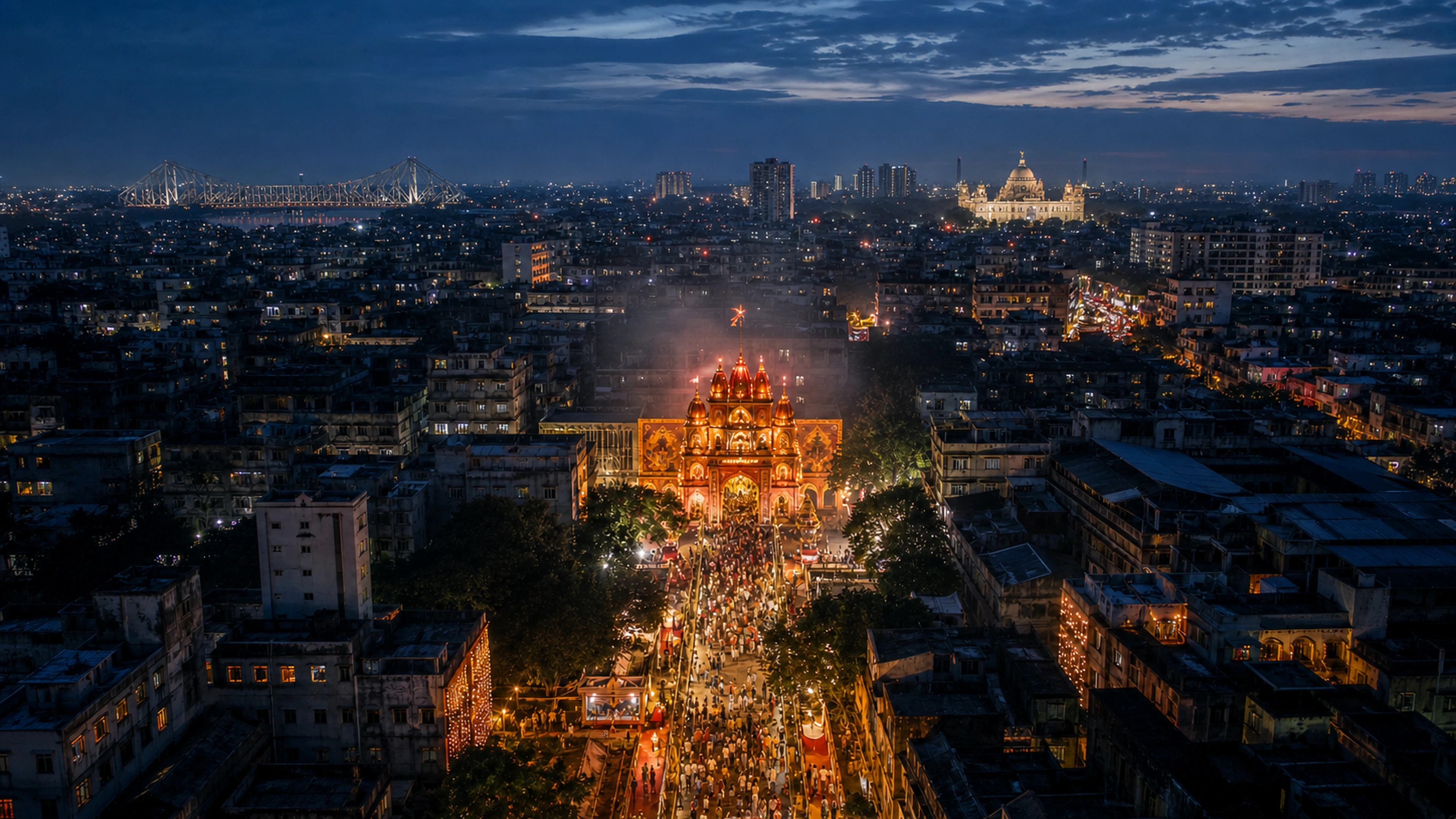 A high drone view descending over Kolkata toward an illuminated Durga Puja pandal, with Howrah Bridge and Victoria Memorial on the horizon
